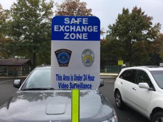 Safe Exchange Zone Sign in a Parking Lot